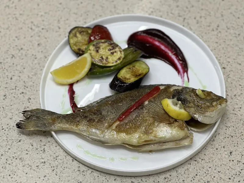 Grilled sea bream with grilled vegetables, lemon and a beetroot purée