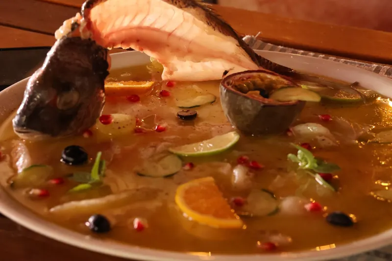 Sea bass carpaccio in a citrus dressing with passion fruit and pomegranate